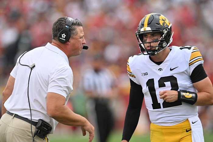 Iowa offensive coordinator Brian Ferentz (left) talks with quarterback Cade McNamara during the Hawkeyes' game against Iowa State.